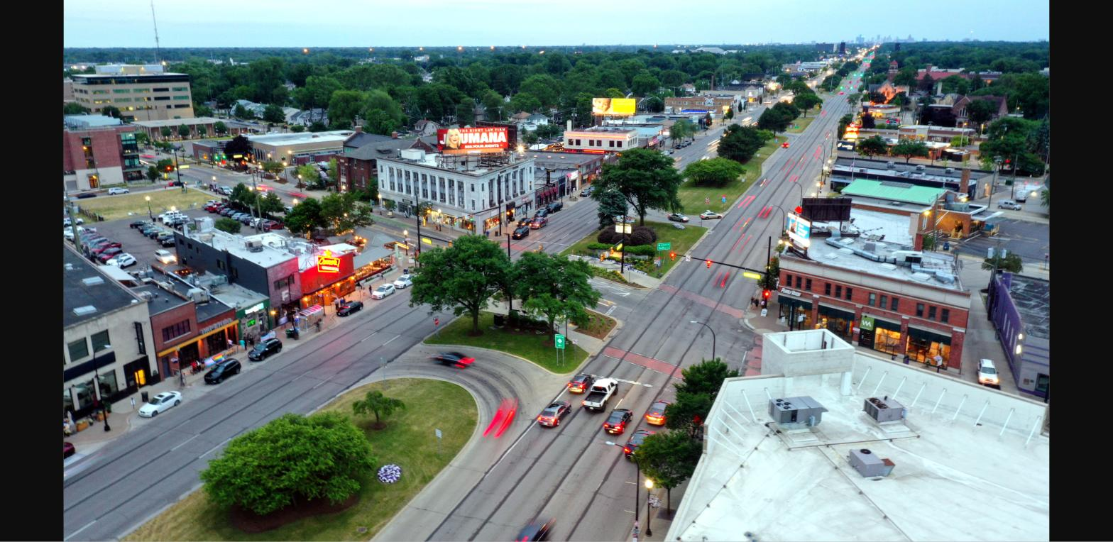 Aerial view of downtown Ferndale, Michigan at dusk with Woodward Avenue traffic