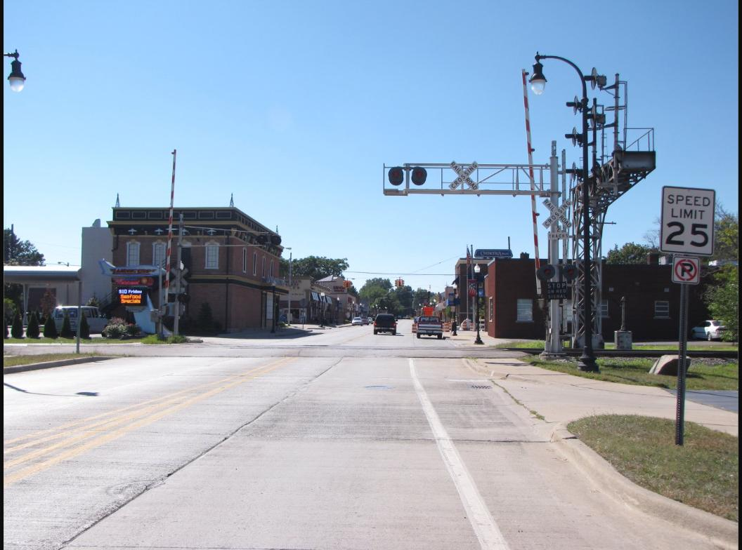 Downtown street in Romulus, Michigan with a railroad crossing