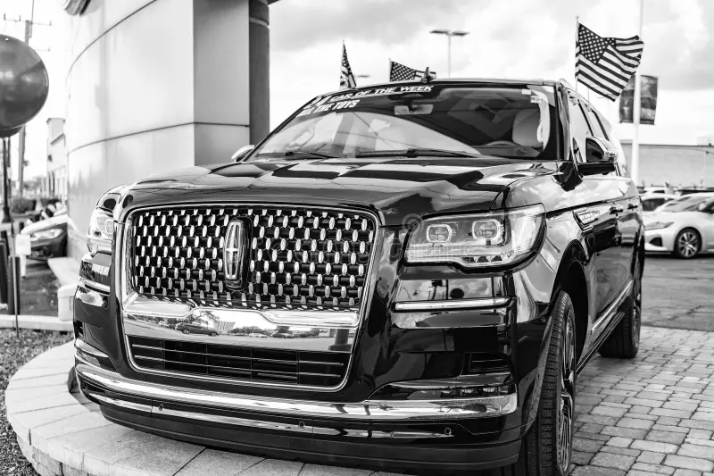 Black Lincoln Navigator L parked outside a downtown building