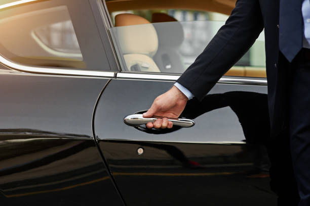 Chauffeur opening the car door for a client